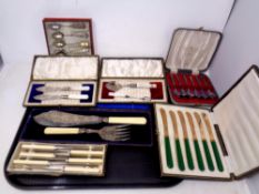 A tray of boxed cutlery sets, cased pair of EPNS fish servers,