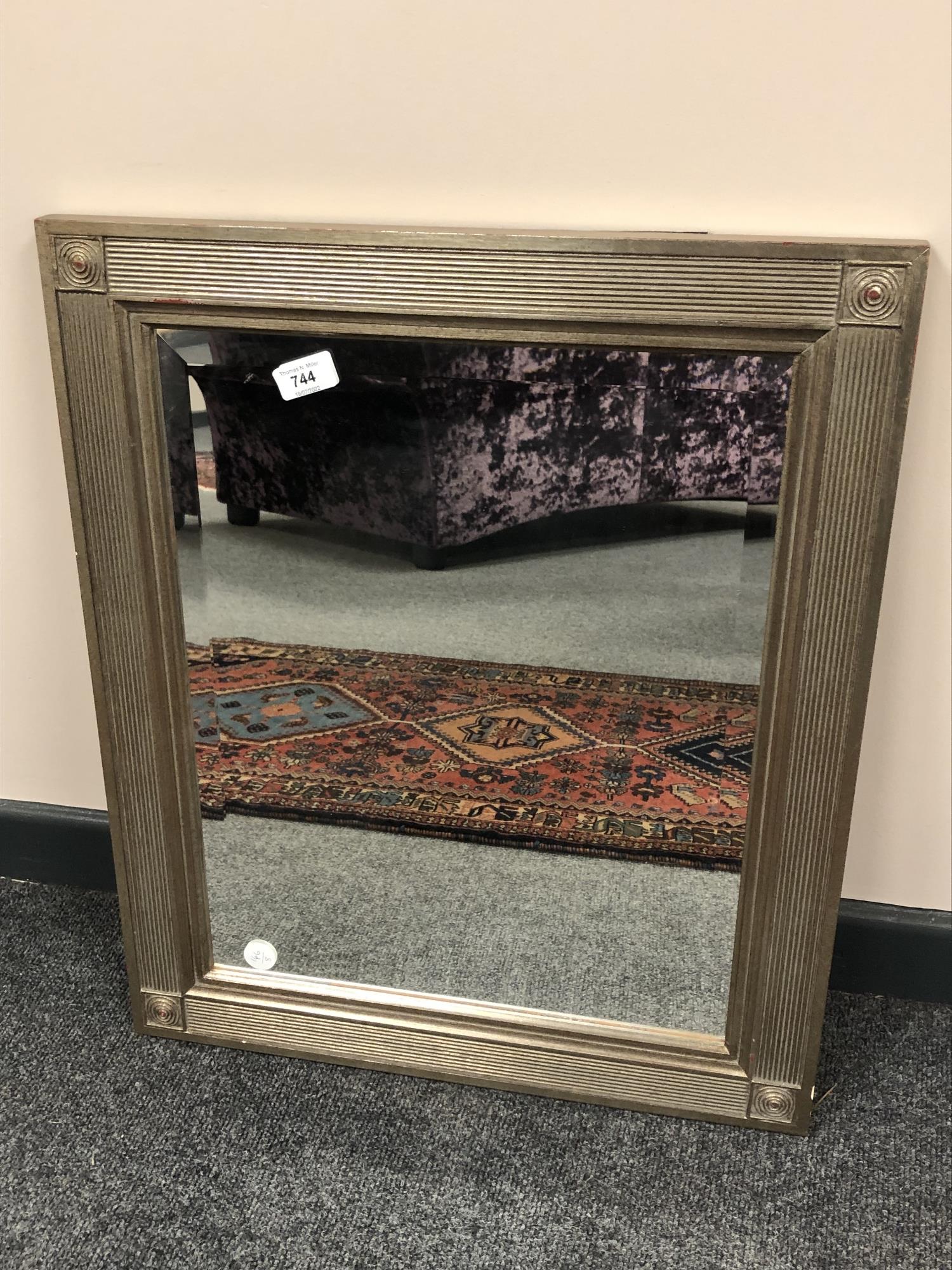 A contemporary mirror in ribbed frame 53 cm x 53 cm