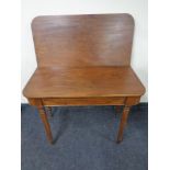 A Victorian mahogany turnover top table fitted a drawer