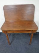 A Victorian mahogany turnover top table fitted a drawer