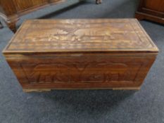 A carved sheesham wood blanket chest