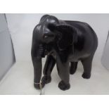 An ebonised wooden elephant figure