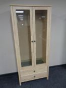 A contemporary pine double door glazed bookcase fitted drawers beneath