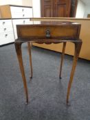 A 20th century walnut occasional table fitted a drawer