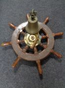 A ship's wheel and a brass ship's bell
