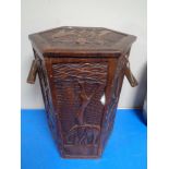 A carved hardwood hexagonal storage stool