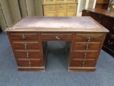A 19th century mahogany writing desk fitted nine drawers with leather inset panel