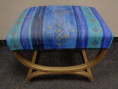 A gilt dressing table stool