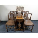 An oak drop leaf table and four chairs,