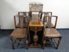 An oak drop leaf table and four chairs,