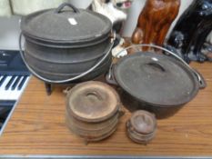 Four various cast iron cooking pots