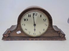 An Edwardian oak mantel clock with silvered dial