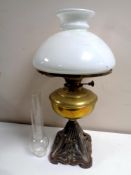 A brass oil lamp on metal base,