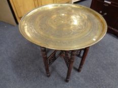 An Indian brass topped folding table