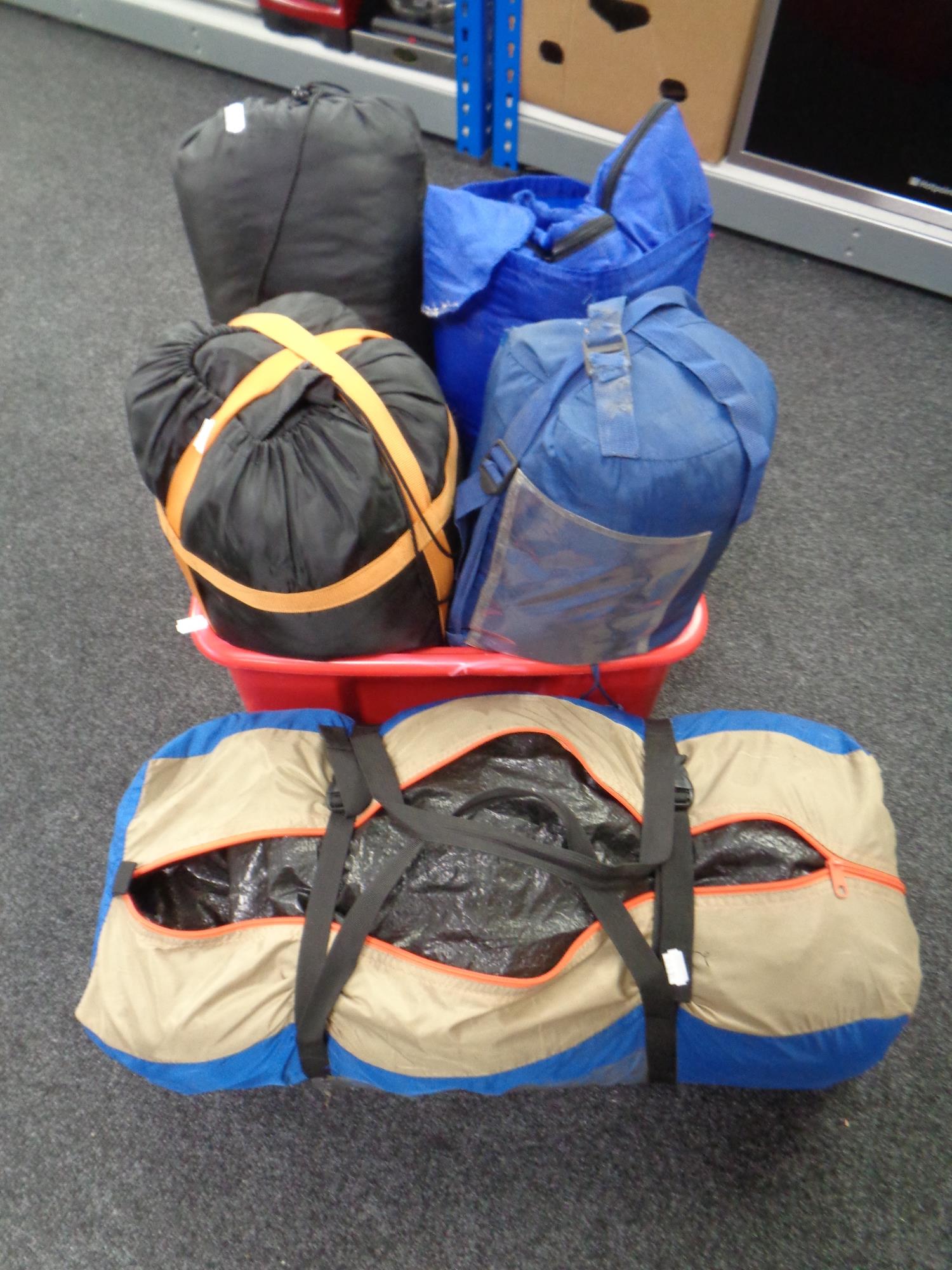 A tent in bag together with four assorted sleeping bags