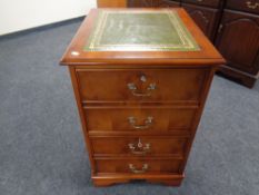 A yew wood two drawer filing cabinet with green tooled leather inset panel