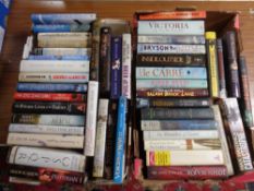 Two boxes containing hardback books to include novels John Le Carré, Bill Bryson,