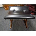 A mid century teak and black vinyl dressing table stool
