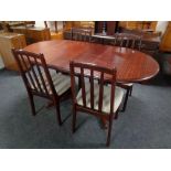 A break fronted sideboard in mahogany finish together with similar dining table and four chairs,