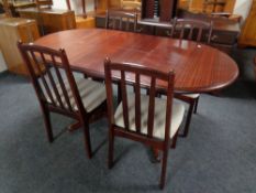 A break fronted sideboard in mahogany finish together with similar dining table and four chairs,