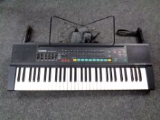 A Casiotone keyboard on stand with power lead
