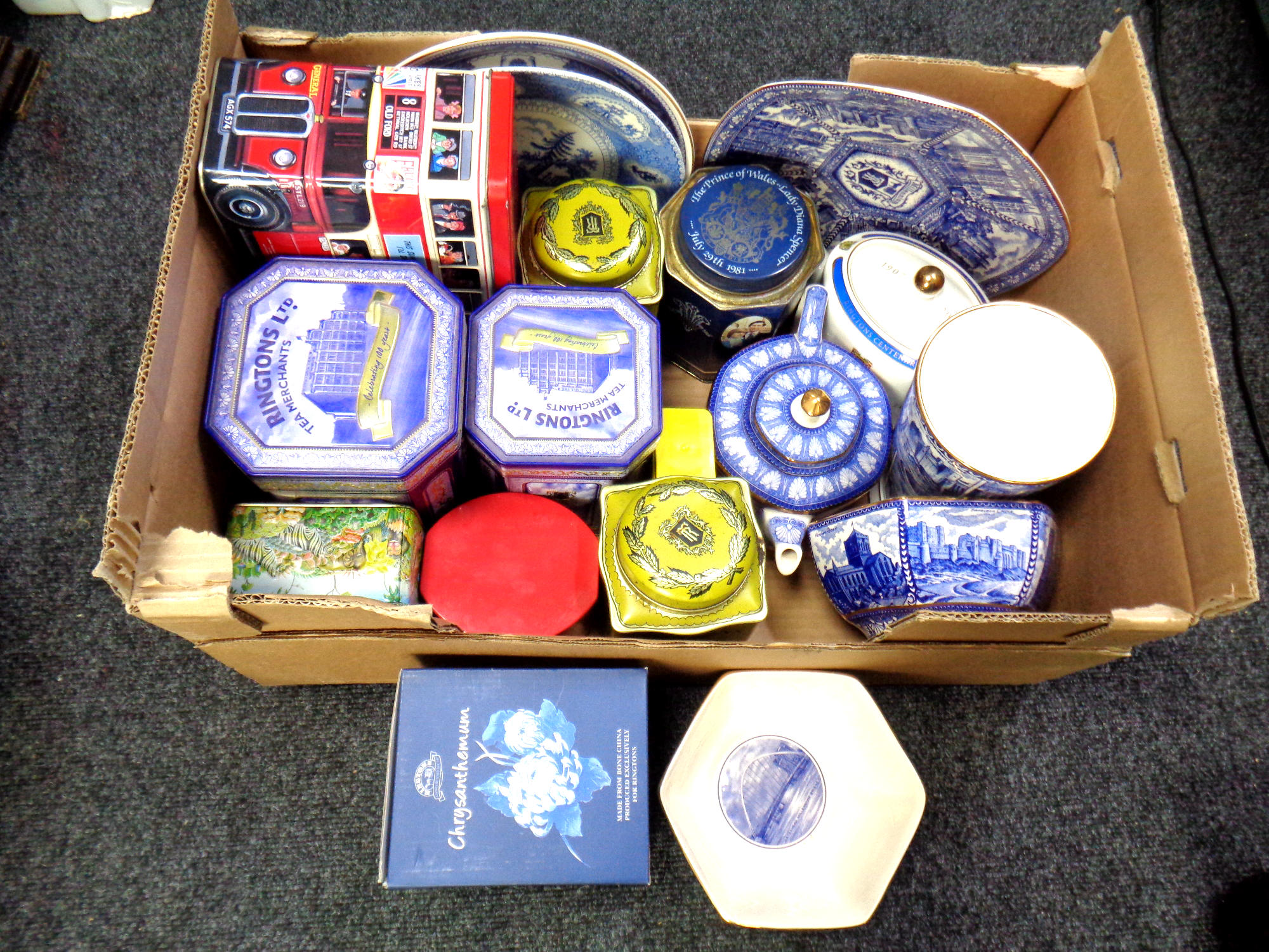 A box containing assorted tins and Ringtons ceramics.