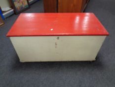 An antique painted pine blanket box