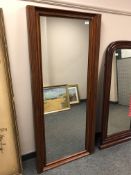 A continental walnut framed mirror 157 cm x 71 cm