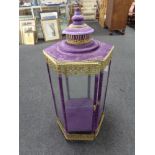 A Moroccan style brass and glass hexagonal counter topped display cabinet in purple velvet