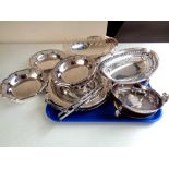 A tray of stainless steel serving plates and swing handled baskets etc