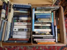 Two boxes containing hardback books relating to war, aviation etc.