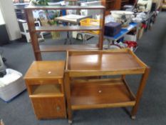 A mid twentieth century two-tiered tea trolley together with a bedside cabinet and a set of open