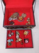 A wooden jewellery box and contents to include costume brooches,