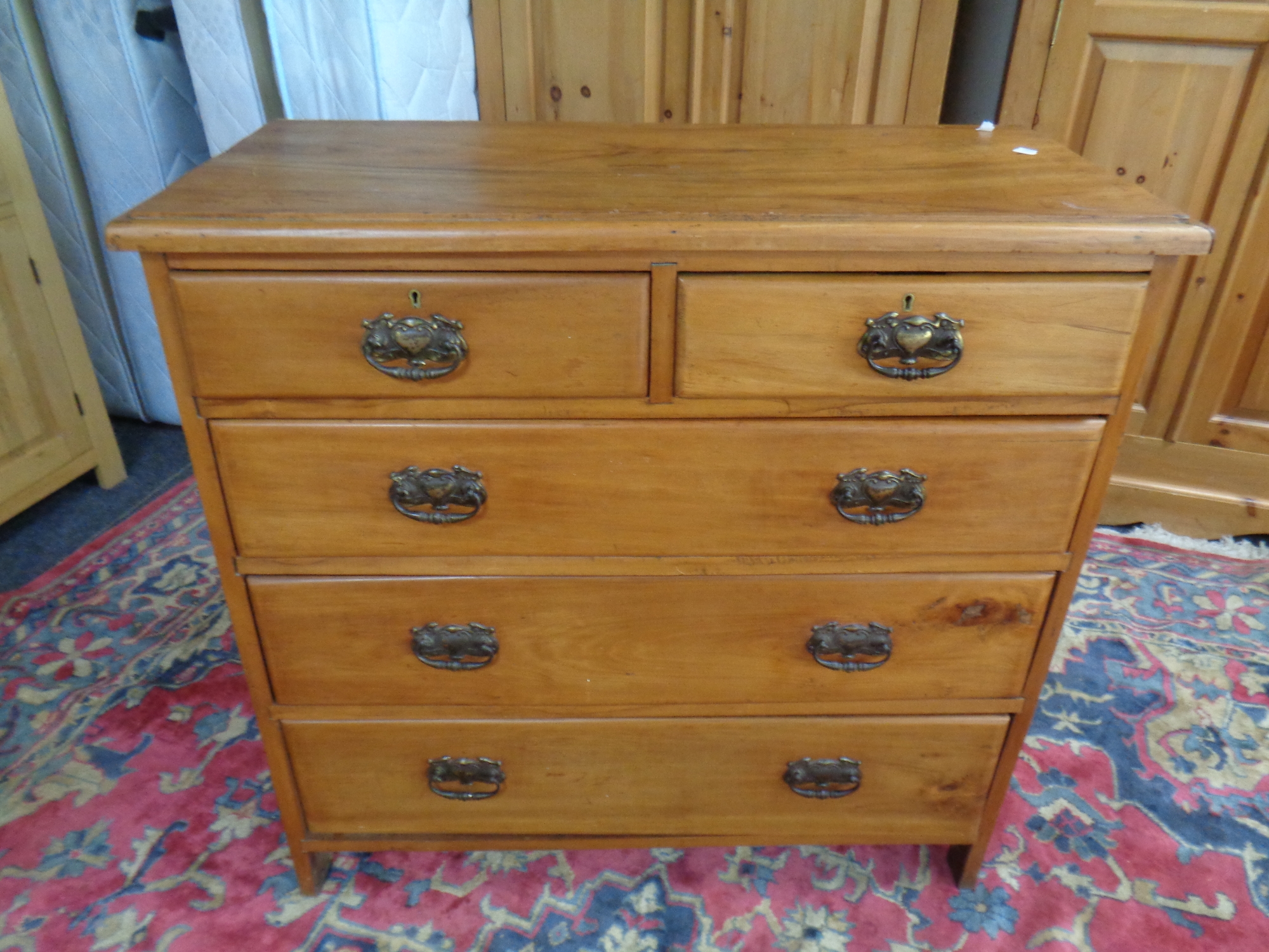 An Edwardian pine five drawer chest