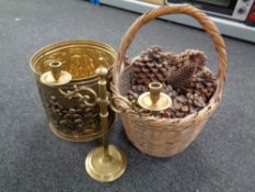 A wicker basket containing acorns together with brass embossed coal bucket and further brass