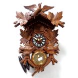 A cuckoo clock with pendulum and weights
