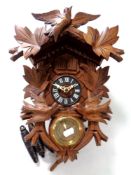 A cuckoo clock with pendulum and weights