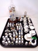 A tray of china thimbles, two thimble stands,