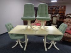 A 1970s refectory turnover top extending dining table together with a set of four pedestal dining