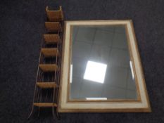A contemporary cream and gilt mirror together with a metal and wicker CD stand
