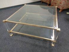 A pair of contemporary metal framed two-tier glass topped coffee tables.