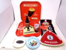 A quantity of Mackeson brewery related items, two tin trays, ceramic and plastic ashtrays,