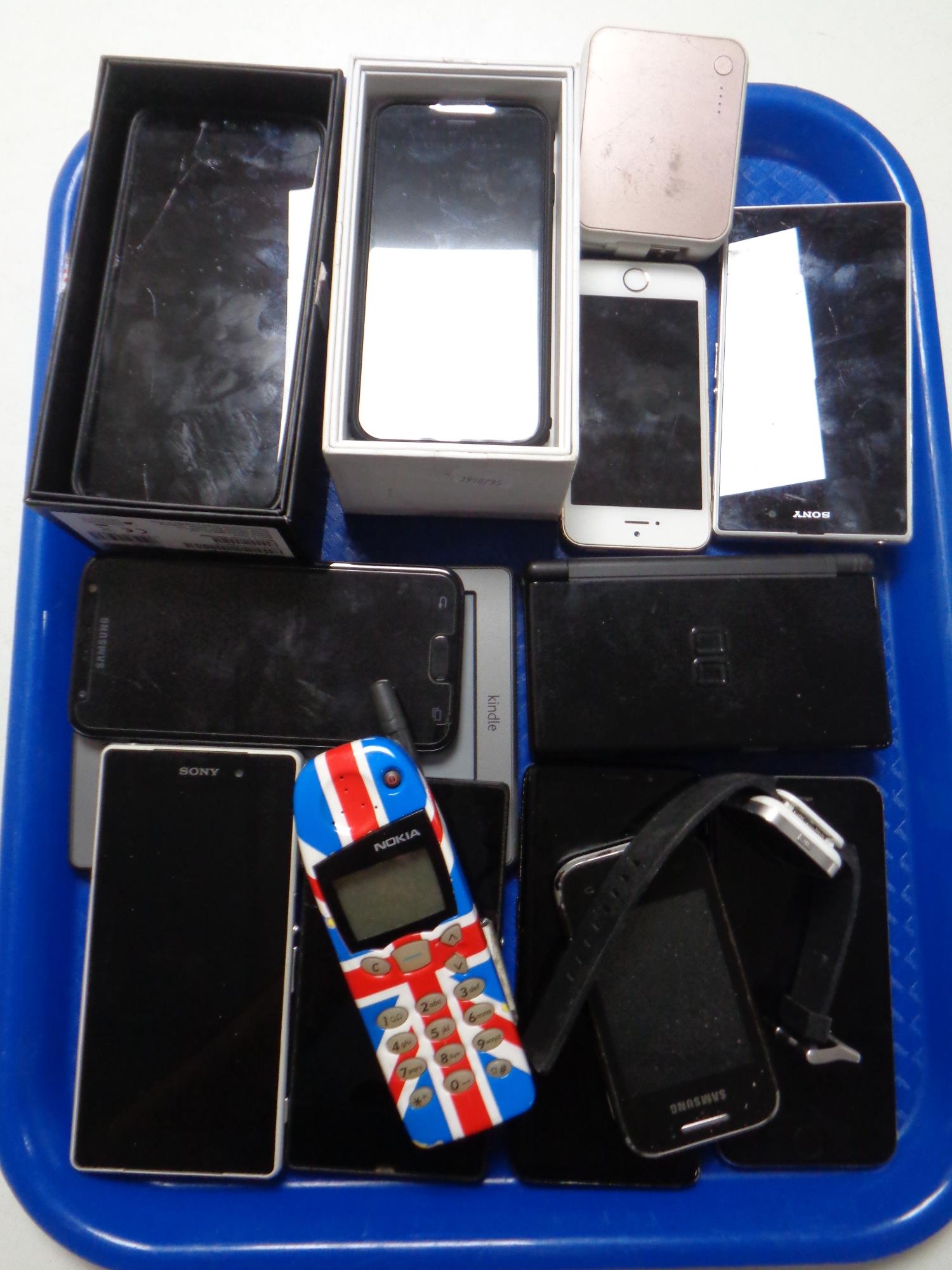 A tray of mobile phones including Apple i phone, Sony,