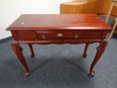 A console table fitted with a drawer in a mahogany finish