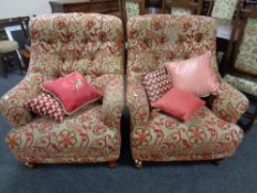 A pair of contemporary Victorian-style button-back armchairs upholstered in a floral fabric with