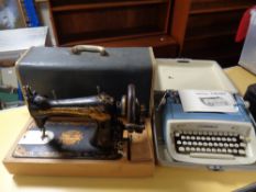 A vintage Singer sewing machine together with typewriter in case
