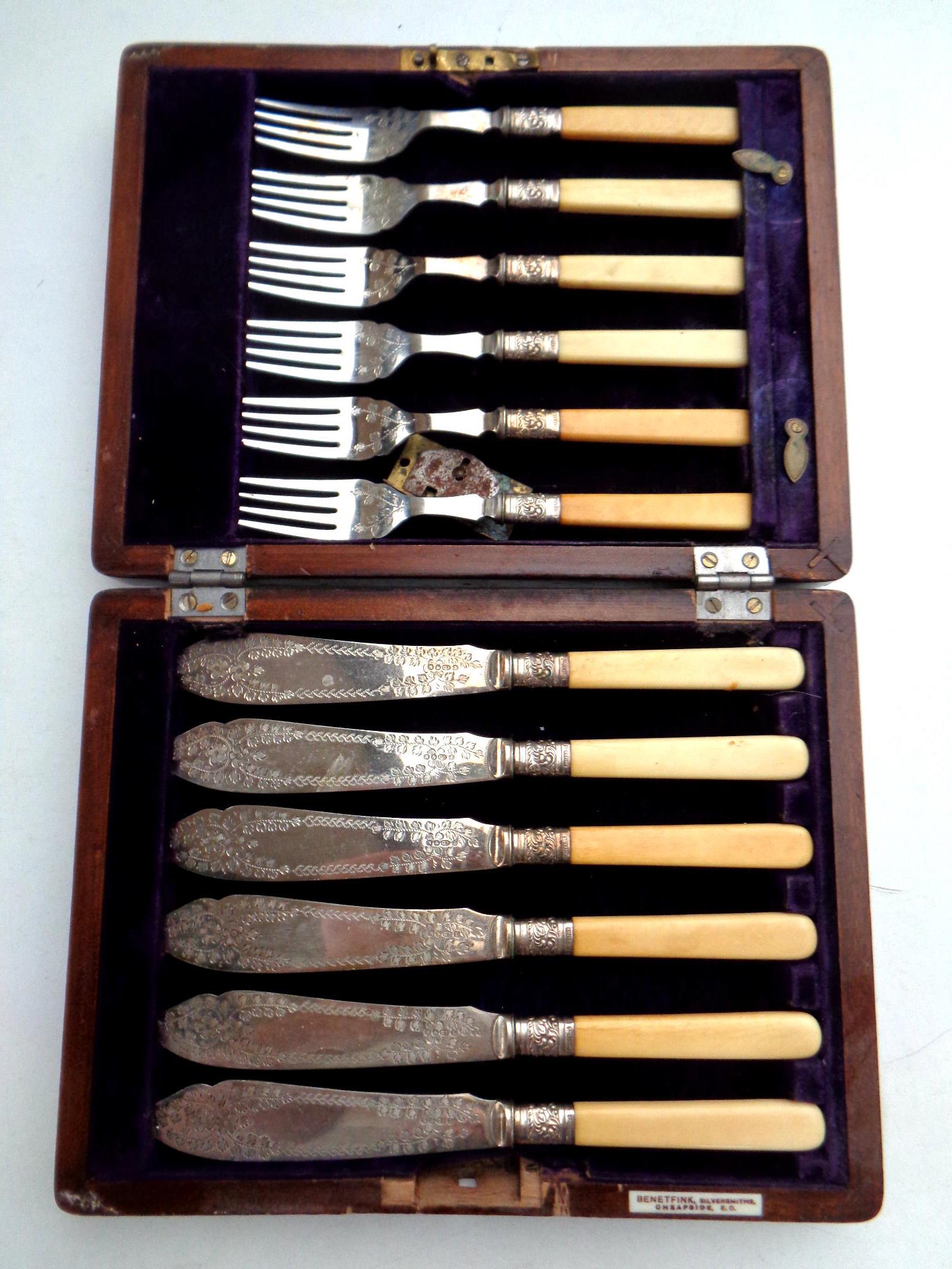 A canteen of silver plated fish cutlery together with a further oak canteen of stainless steel