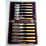 A canteen of silver plated fish cutlery together with a further oak canteen of stainless steel