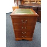 A yew wood two drawer filing cabinet with green tooled leather inset panel