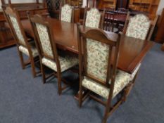 An Old Charm oak refectory extending dinning table together with six chairs upholstered in a floral